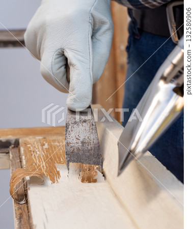 Carpenter at work, restoring an old wooden window. Carpentry. 132580906