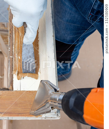 Carpenter at work, restoring an old wooden window. Carpentry. 132580909
