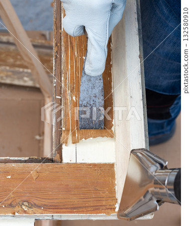 Carpenter at work, restoring an old wooden window. Carpentry. 132580910
