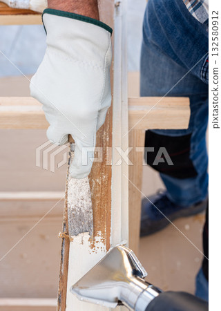 Carpenter at work, restoring an old wooden window. Carpentry. 132580912