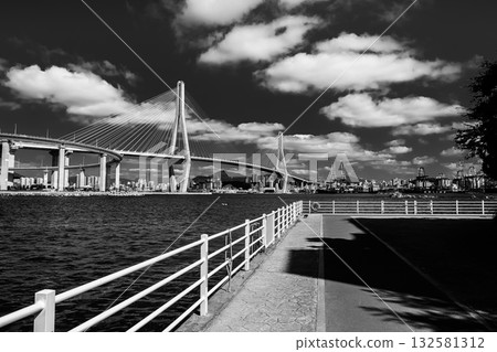 Busan cityscape with Gwangandaegyo Bridge spanning bay in black and white Busan cityscape with Gwangandaegyo Bridge spanning bay in black and white 132581312