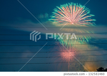 Tokyo cityscape in Japan, Tamagawa Fireworks Festival 2025. The venue side of the 47th Setagaya Ward Tamagawa Fireworks Festival, with the Tokyo Metropolitan Government Building in Shinjuku in the background. Tokyo cityscape in Japan, Tamagawa Fireworks Festival 2025. The venue side of the 47th Setagaya Ward Tamagawa Fireworks Festival, with the Tokyo Metropolitan Government Building in Shinjuku in the background. 132581460