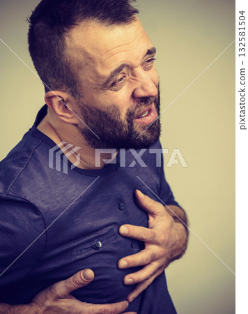 Man having heart pain attack Man having heart pain attack 132581504