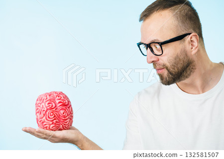 Man looking at human brain Man looking at human brain 132581507