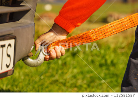 Male hand attaching towline to car 132581587
