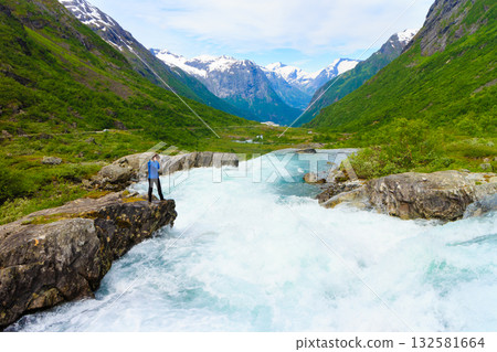 Tourist woman by Videfossen Waterfall in Norway 132581664