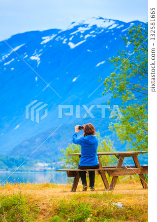 Tourist taking photo at norwegian fjord 132581665