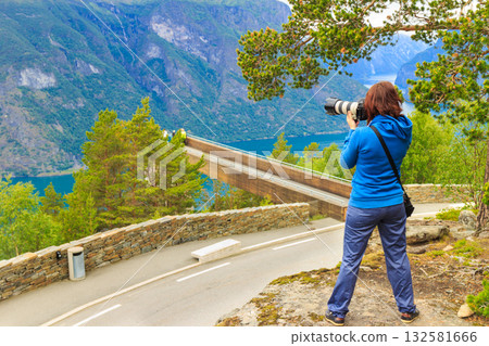 Tourist taking photo from Stegastein viewpoint Norway Tourist taking photo from Stegastein viewpoint Norway 132581666