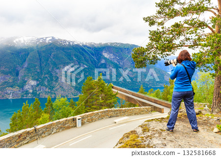 Tourist taking photo from Stegastein viewpoint Norway Tourist taking photo from Stegastein viewpoint Norway 132581668