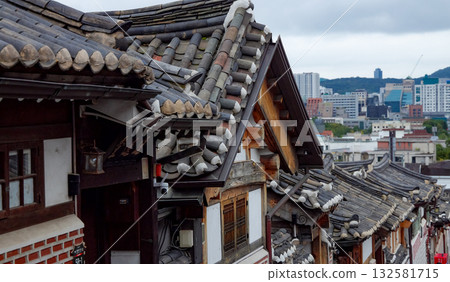 Bukchon Hanok Village rooftops contrasting Seoul cityscape 132581715