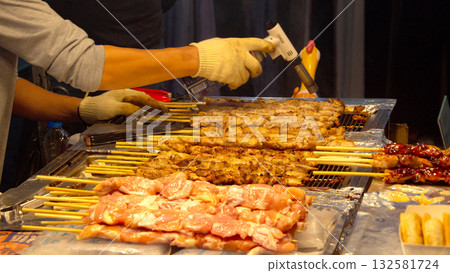 Street food vendor cooking chicken skewers with blowtorch in Seoul Street food vendor cooking chicken skewers with blowtorch in Seoul 132581724