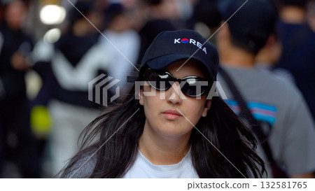 Woman wearing Korea cap and sunglasses in Seoul street 132581765