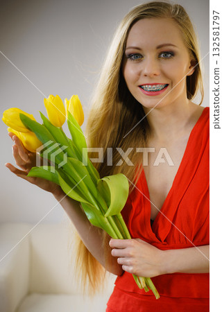 Pretty woman with yellow tulips bunch Pretty woman with yellow tulips bunch 132581797