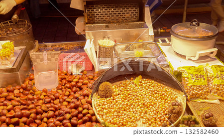 Seoul street market vendor roasting fresh chestnuts Seoul street market vendor roasting fresh chestnuts 132582460