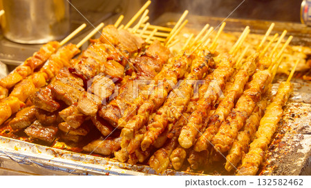 Korean street food grilling skewers in Seoul market Korean street food grilling skewers in Seoul market 132582462