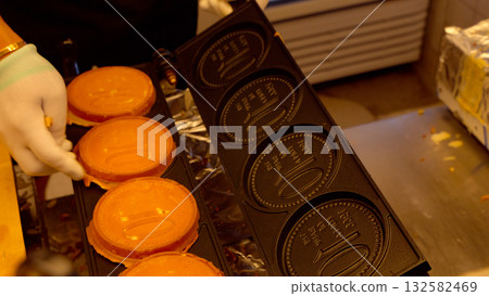 Hand baking Korean coin bread street food in Seoul Hand baking Korean coin bread street food in Seoul 132582469