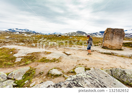 Tourist with camera in Norway mountains Tourist with camera in Norway mountains 132582652