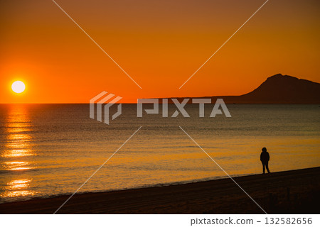 Person silhouette on beach enjoy sunrise 132582656