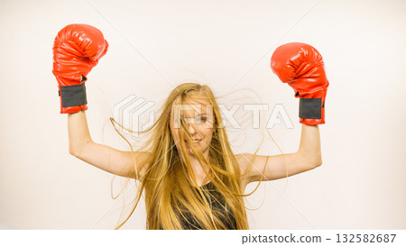 Woman in red gloves with arms up Woman in red gloves with arms up 132582687