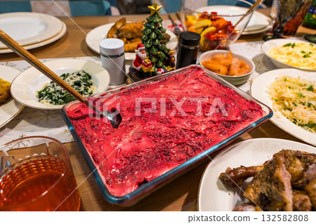 Traditional festive table with herring under a fur coat salad and homemade holiday dishes 132582808