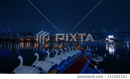 Seoul Han River night view with swan boats 132583183