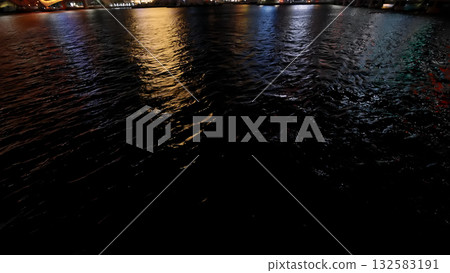 Busan city lights reflecting on dark night water Busan city lights reflecting on dark night water 132583191