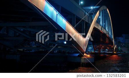 Busan bridge reflecting vibrant lights on water at night 132583201