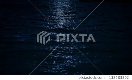 Moonlight reflecting on ocean ocean water surface at night Moonlight reflecting on ocean ocean water surface at night 132583202