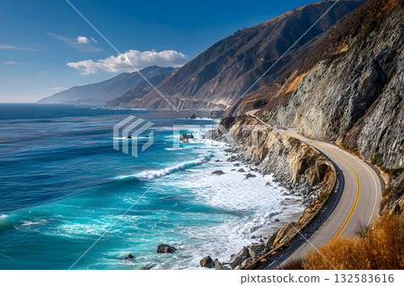 A winding road follows the dramatic coastline, showing a beautiful travel landscape with ocean waves crashing. 132583616