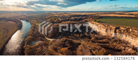 Aerial photo of abandoned chalk quarry near the river. Beautiful landscape of high cliff near the river in countryside 132584178