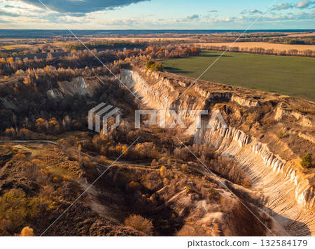 Abandoned chalk quarry. Aerial photo of high chalk cliffs 132584179