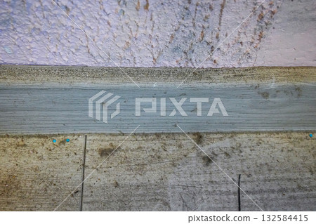 Mold and mildew growing in the corner where wall, floor, and baseboard meet. Concept of moisture damage, damp interior, and unhealthy home conditions. Mold and mildew growing in the corner where wall, floor, and baseboard meet. Concept of moisture damage, damp interior, and unhealthy home conditions. 132584415