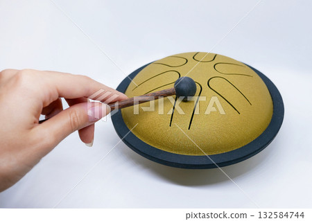 Hand Playing Tongue Drum with Mallet Hand Playing Tongue Drum with Mallet 132584744