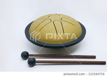 Golden Tongue Drum with Wooden Mallets on White Background Golden Tongue Drum with Wooden Mallets on White Background 132584758