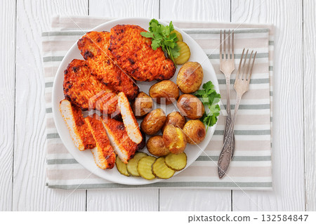 Paprika-Rubbed Pork Chops on plate with potatoes Paprika-Rubbed Pork Chops on plate with potatoes 132584847