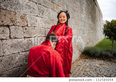Interracial couple celebrating Chinese wedding ceremony tradition Interracial couple celebrating Chinese wedding ceremony tradition 132585054