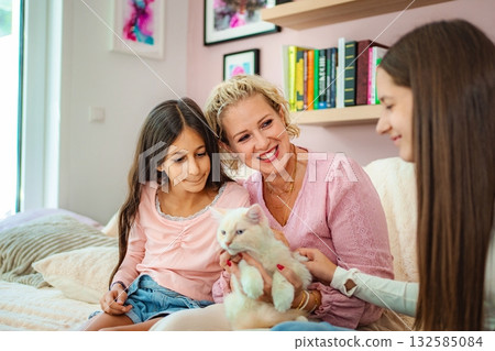 Family bonding with pet cat at home 132585084