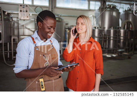 Women entrepreneurs making a phone call, managing brewery business Women entrepreneurs making a phone call, managing brewery business 132585145