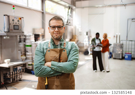 Man brewer owner portrait standing in craft brewery Man brewer owner portrait standing in craft brewery 132585148