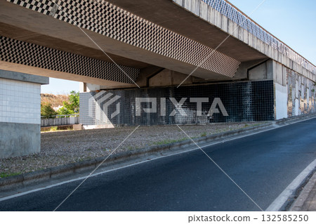 Under the bridge in the middle of the road. Urban landscape. 132585250