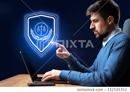 Legal professional engaged in digital security tasks at a workstation 132585352