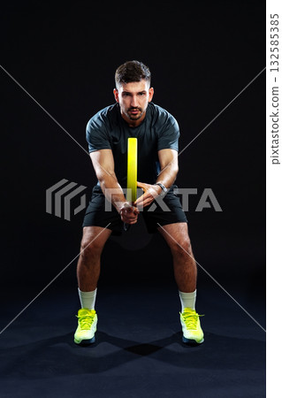 Training session with a male athlete using a resistance band indoors Training session with a male athlete using a resistance band indoors 132585385