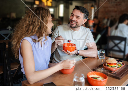 Couple enjoying a healthy meal together at a restaurant 132585466