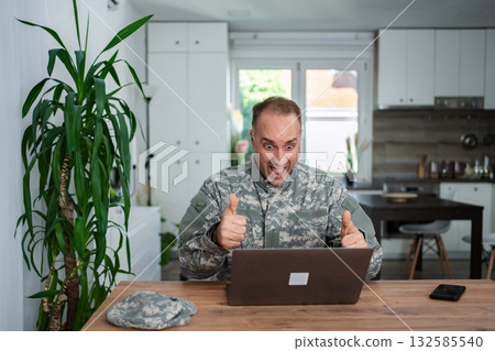 Excited soldier making a video call with his family Excited soldier making a video call with his family 132585540