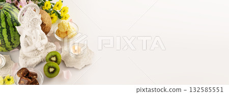 Holiday of Ganesh Chaturthi banner. Sculpture of ganesha with offerings, fruits, sweets, flowers and candles on white background with copy space. Lord Ganesha, Ganesh festival. Hindu religion holiday Holiday of Ganesh Chaturthi banner. Sculpture of ganesha with offerings, fruits, sweets, flowers and candles on white background with copy space. Lord Ganesha, Ganesh festival. Hindu religion holiday 132585551