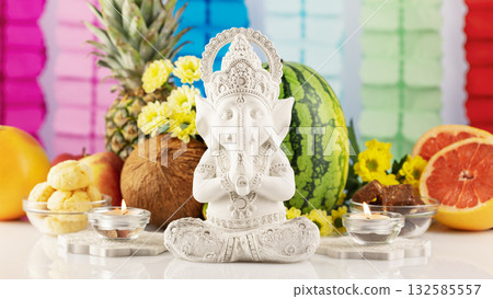 Holiday of Ganesh Chaturthi. Sculpture of ganesha with offerings, fruits, sweets, flowers and candles on a light background with decorations. Lord Ganesha , Ganesh festival. Hindu religion holiday Holiday of Ganesh Chaturthi. Sculpture of ganesha with offerings, fruits, sweets, flowers and candles on a light background with decorations. Lord Ganesha , Ganesh festival. Hindu religion holiday 132585557