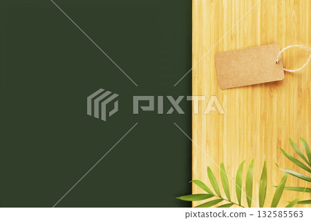 Eco friendly, natural background. Empty, dark green table and wooden kitchen board with palm leaves and empty, craft label. Mock up for display or montage of spa relax products, dishes or food Eco friendly, natural background. Empty, dark green table and wooden kitchen board with palm leaves and empty, craft label. Mock up for display or montage of spa relax products, dishes or food 132585563