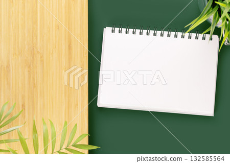 Eco friendly, natural background. Green table with notebook with white blank sheet for your text and wooden board with home plants. Mock up for inscription 132585564