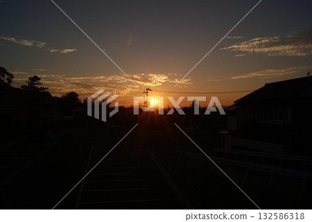 The morning sun shining over the approach and the silhouette of the large torii gate The morning sun shining over the approach and the silhouette of the large torii gate 132586318