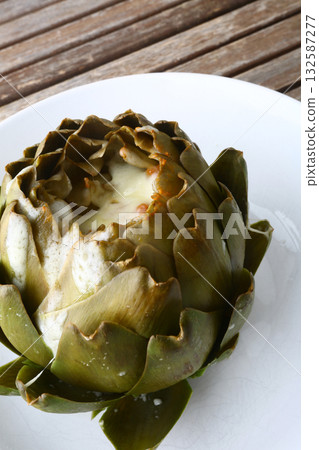 cooked seasonal artichoke with cheese and sobrasada cooked seasonal artichoke with cheese and sobrasada 132587277